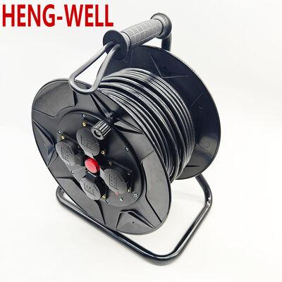 Черная выдвижная кабельная катушка для наружного использования, разработанная для удобного развертывания и сматывания кабеля в сложных условиях на открытых рабочих площадках